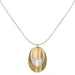 Layered Dished Ovals Necklace featuring three stacked brass and silver ovals on a silver snake chain, showcasing a unique concave design.