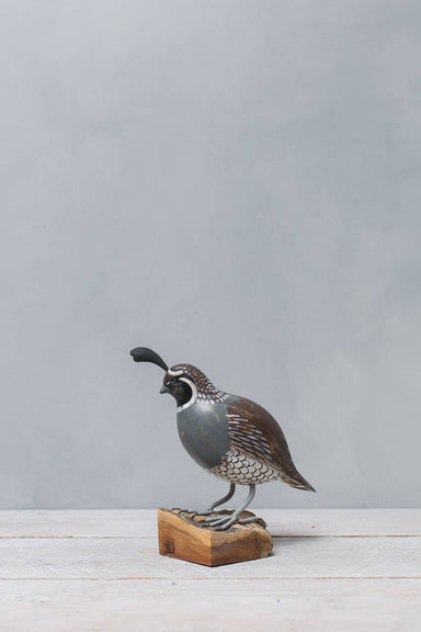 painted quail on wood stump