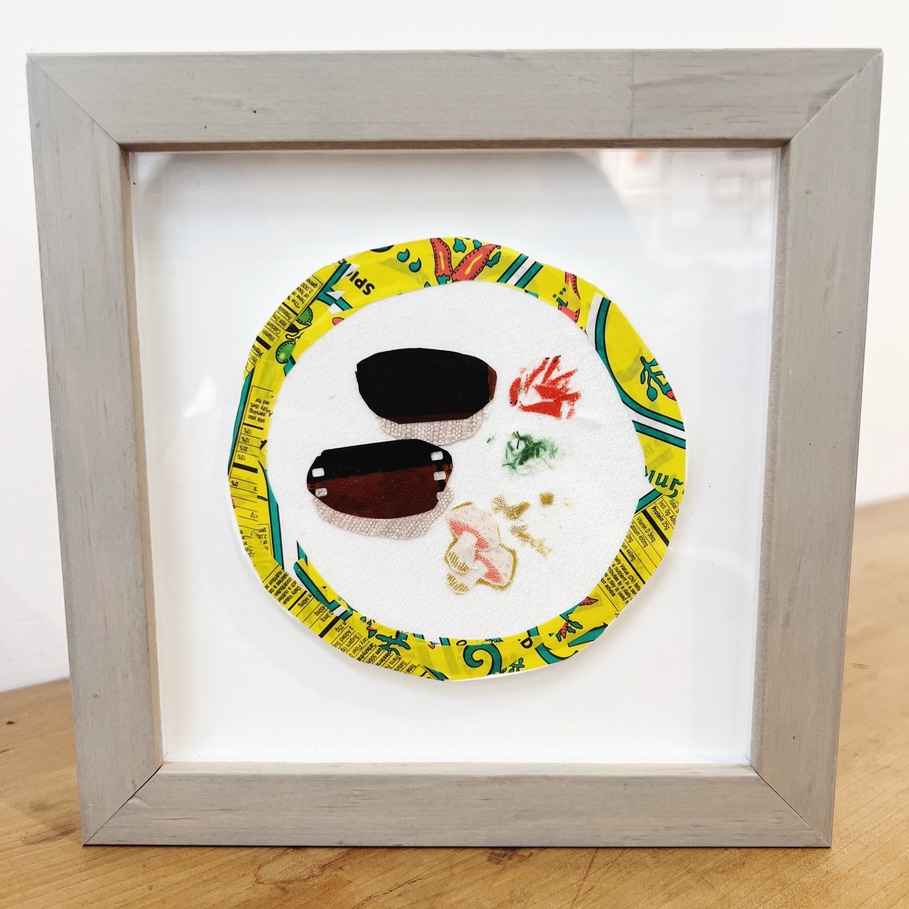 mixed media artwork in a frame