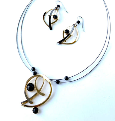 wire necklaces and earrings featuring black beads and gemstones