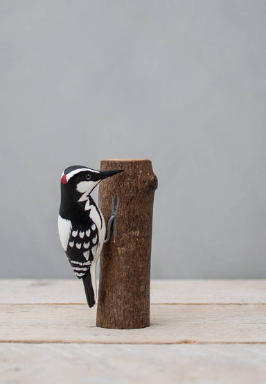 painted woodpecker on wood stump