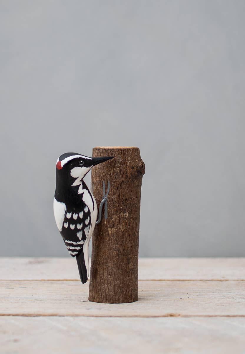 painted woodpecker on wood stump