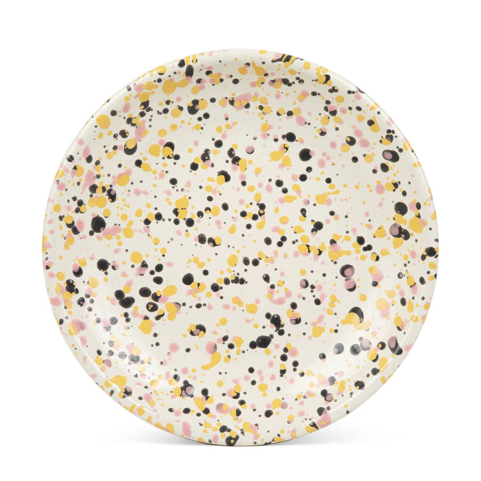 Crow Canyon Home Catalina Enamelware Coupe Dinner Plate exhibiting a playful speckled design with pastel pink, black, and yellow dots on a cream surface.
