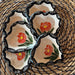 Four Floral Sgraffito Heart Trinket Dishes showcasing hand-carved orange flowers with green accents, beautifully displayed by Tough Kitty Designs.