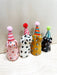 Colorful collection of mini party dogs in party hats, handcrafted by Bianca Rae, featuring playful designs with polka dots and stripes, titled 'Party Minis!'