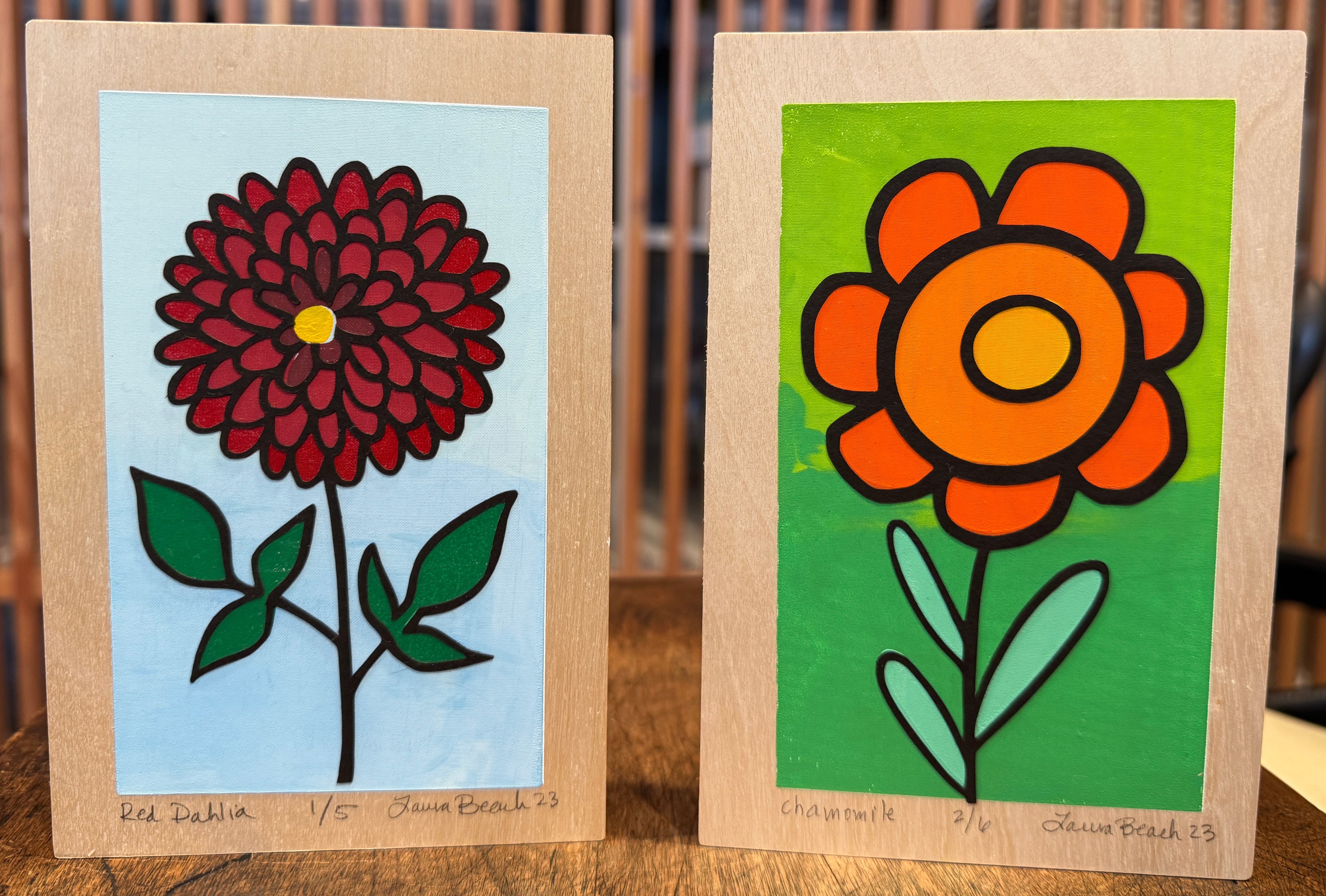 Artwork titled 'Hearts for the Arts | Chamomile & Dahlia' by Hearts for the Arts, showcasing two vibrant hand-crafted flower designs. Features a red Dahlia and a colorful Chamomile with hand-cut paper details by artist Laura Beach.