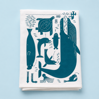 Charming Doug Ross Tea Towel with playful whales & seals, your new witty kitchen companion that dries glassware while making every meal a splash of fun!