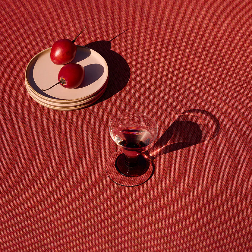 Chilewich Mini Basketweave Woven Floor Mat - Scarlet with a cocktail glass and plates
