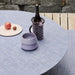 Chilewich Mini Basketweave Woven Floor Mat - Periwinkle on a dining table with wine