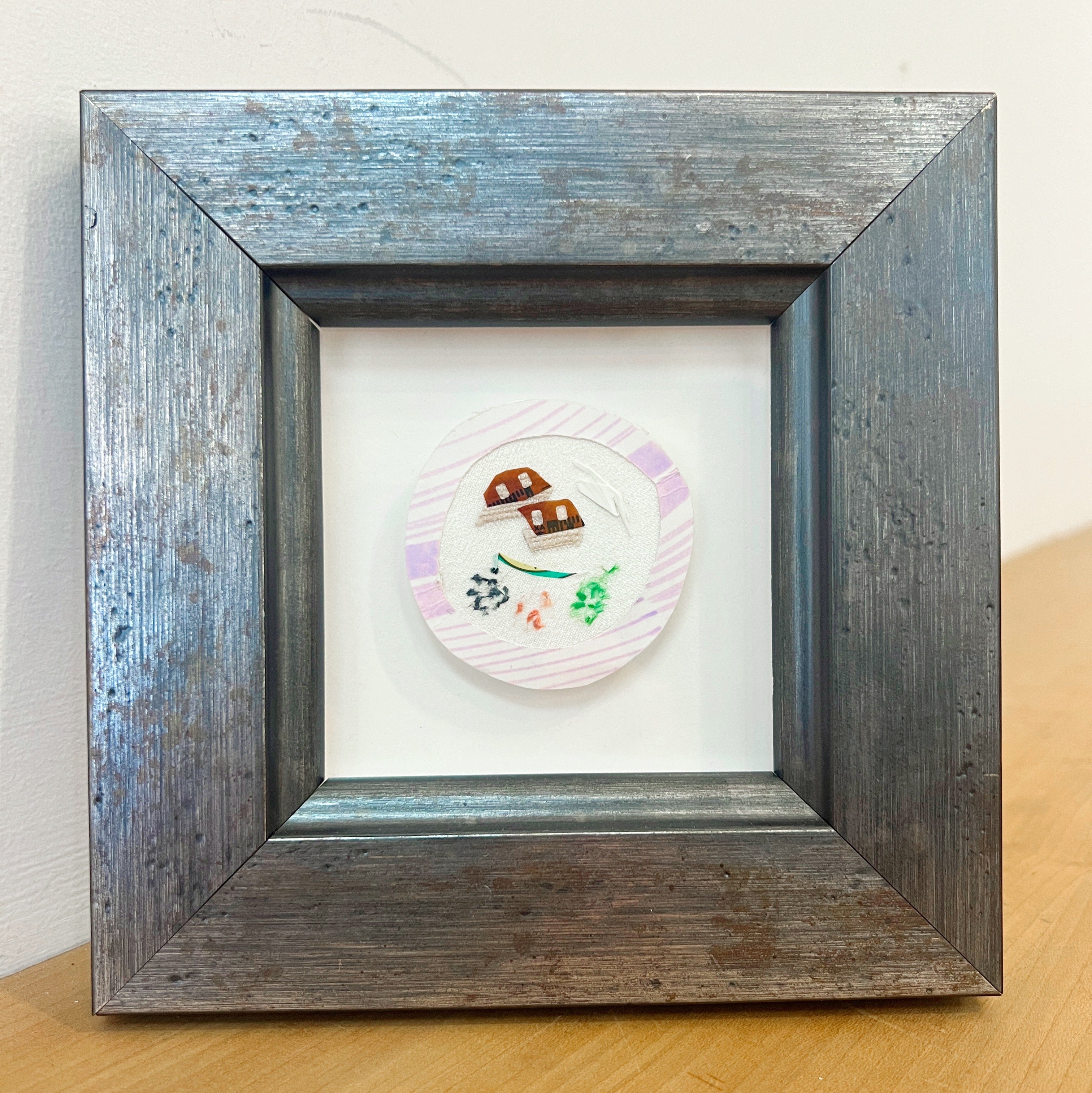 mixed media artwork in a frame