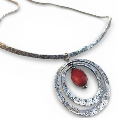 Close-up view of Sterling Silver Necklace and Pendant with Antique Amber Bead by Deb Collins, highlighting intricate metalwork and natural-inspired design.