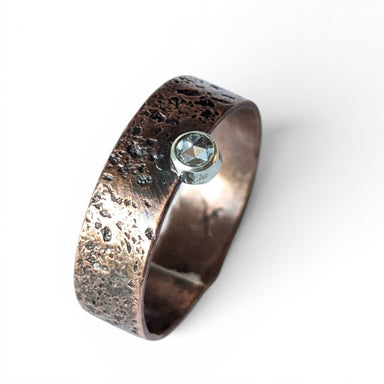Handmade copper ring featuring a stunning faceted white sapphire stone, crafted by jewelry artist Deb Collins, known for her unique nature-inspired designs.