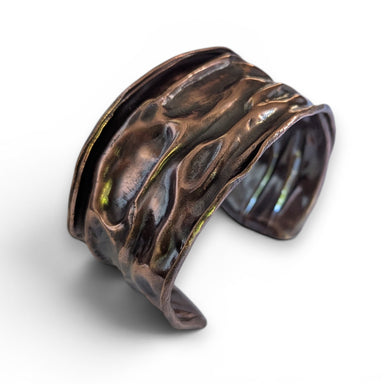 Hand Folded Copper Cuff Bracelet by Deb Collins, showcasing intricate handmade metalwork inspired by organic shapes and ancient textures.