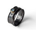 Folded copper ring with faceted blue sapphire by Deb Collins, showcasing unique handmade jewelry inspired by natural shapes.