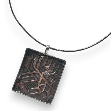 Handmade Copper and Sterling Silver Cutout Necklace by Deb Collins, featuring organic shapes inspired by nature and ancient textures. Perfect for nature lovers and unique jewelry enthusiasts.