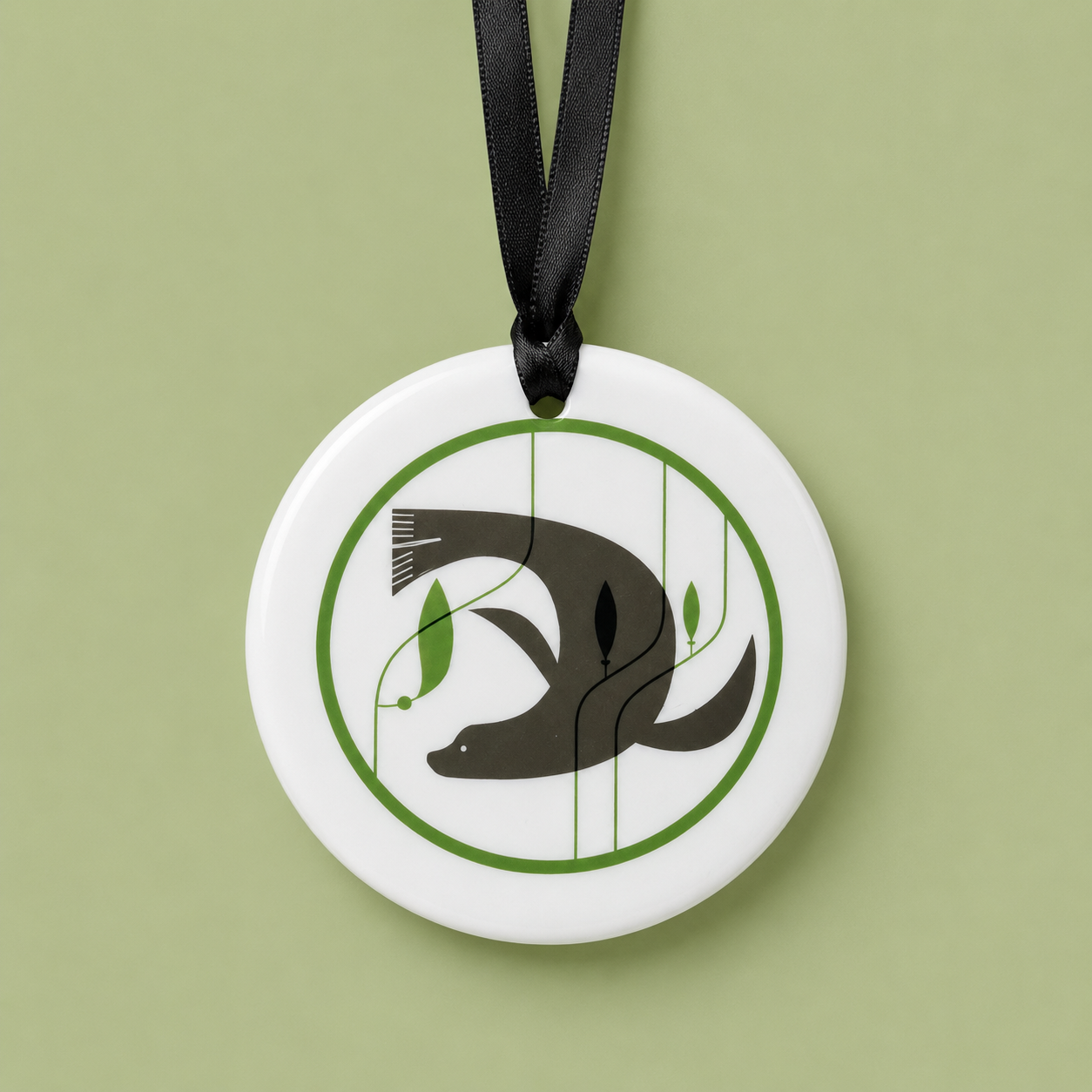 Decorative pendant with a seal
 design on a white background