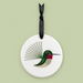 Round ceramic ornament with a hummingbird design on a light green background