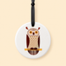 Round ceramic ornament with owl design on a beige background