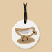Round ceramic ornament with a sandpiper design on a beige background