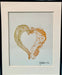 Art piece titled 'Hearts for the Arts | Love a Slug' by Hearts for the Arts, featuring a banana slug and a Monterey Dorid embracing in a heart shape, framed with a signature from the artist.
