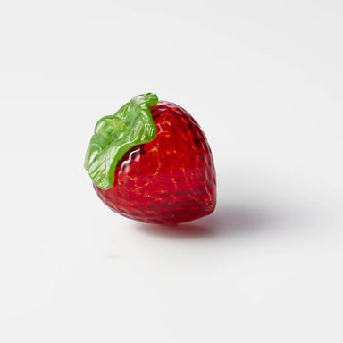 Red strawberry-shaped glass ornament with green leaves 