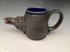 Artistic stoneware mug by Hearts for the Arts, named 'Steal My Heart', showcasing a whimsical raven head sculpture with an expressive eye and vibrant blue interior, perfect for collectors.
