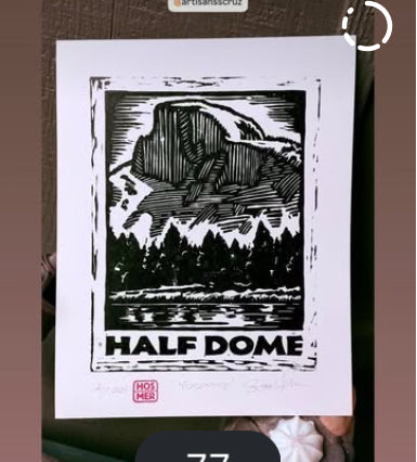 Linoleum block print titled 'Half Dome' by Hearts for the Arts, featuring a detailed depiction of Half Dome mountain surrounded by trees, showcasing the intricate craftsmanship of Stephen Hosmer.