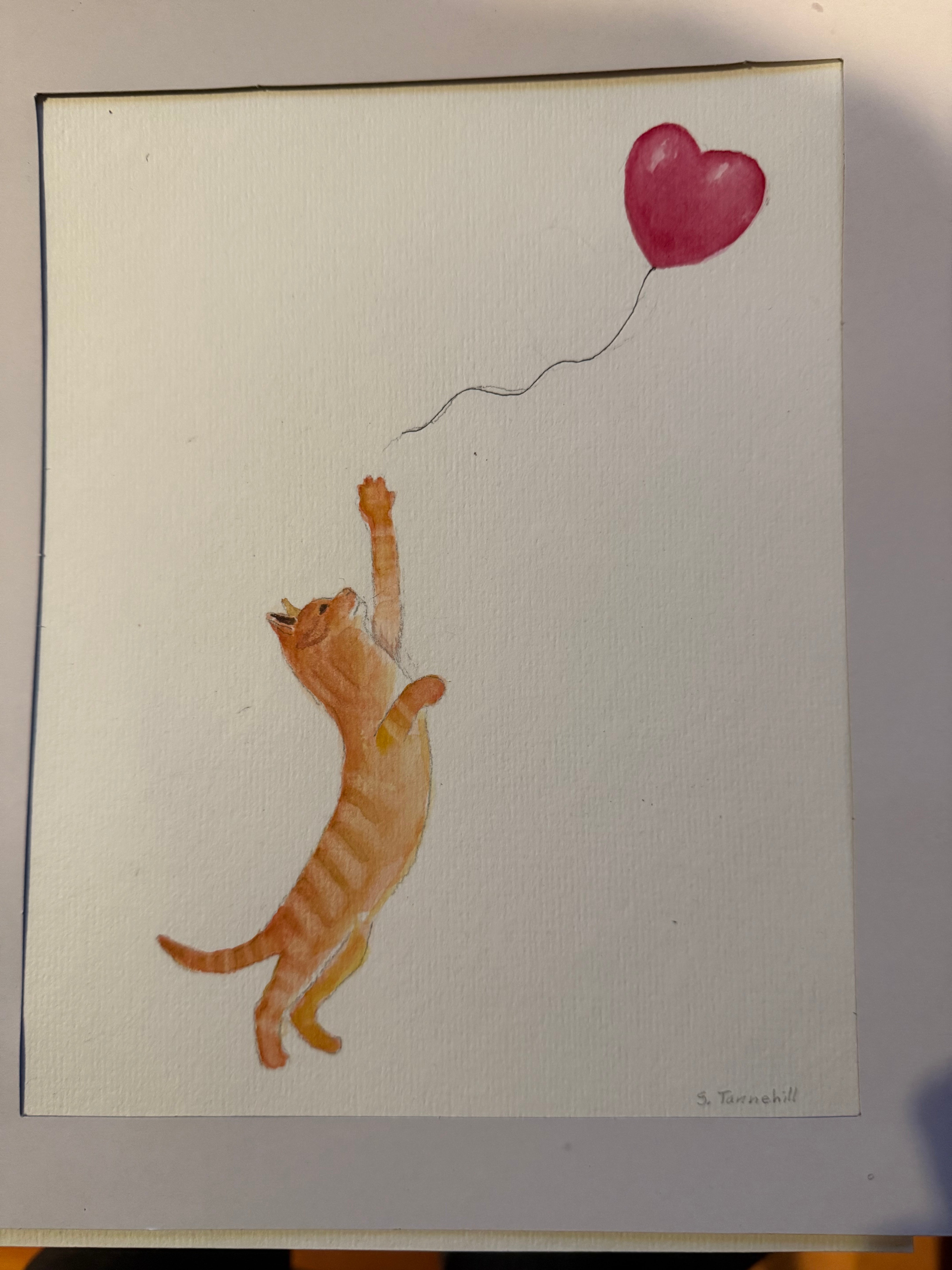 Watercolor painting by Hearts for the Arts featuring a playful cat reaching for a red balloon string, titled 'Hearts for the Arts | Cat Reaching for the Balloon String', measuring 10" by 12".