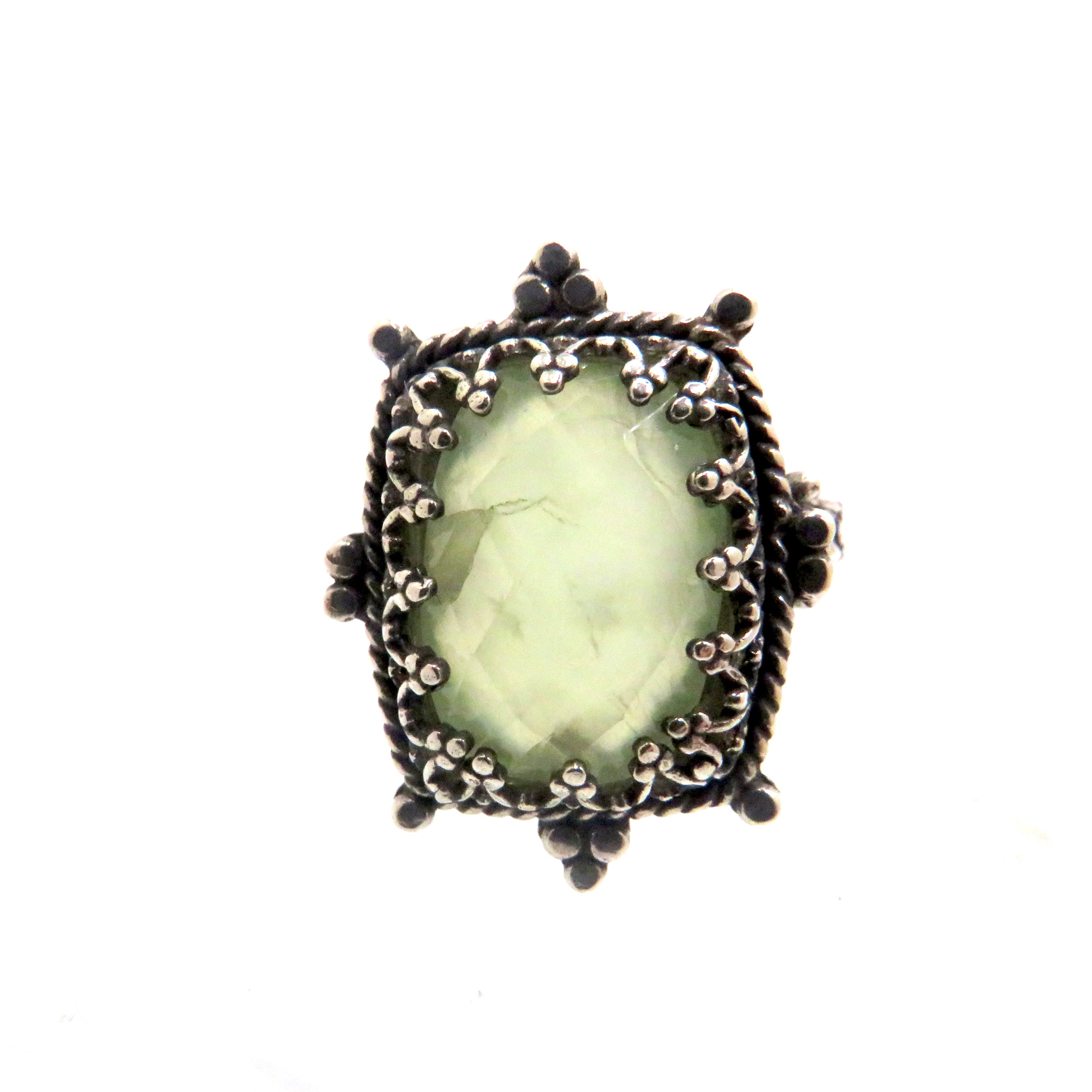 silver ring with green gemstone