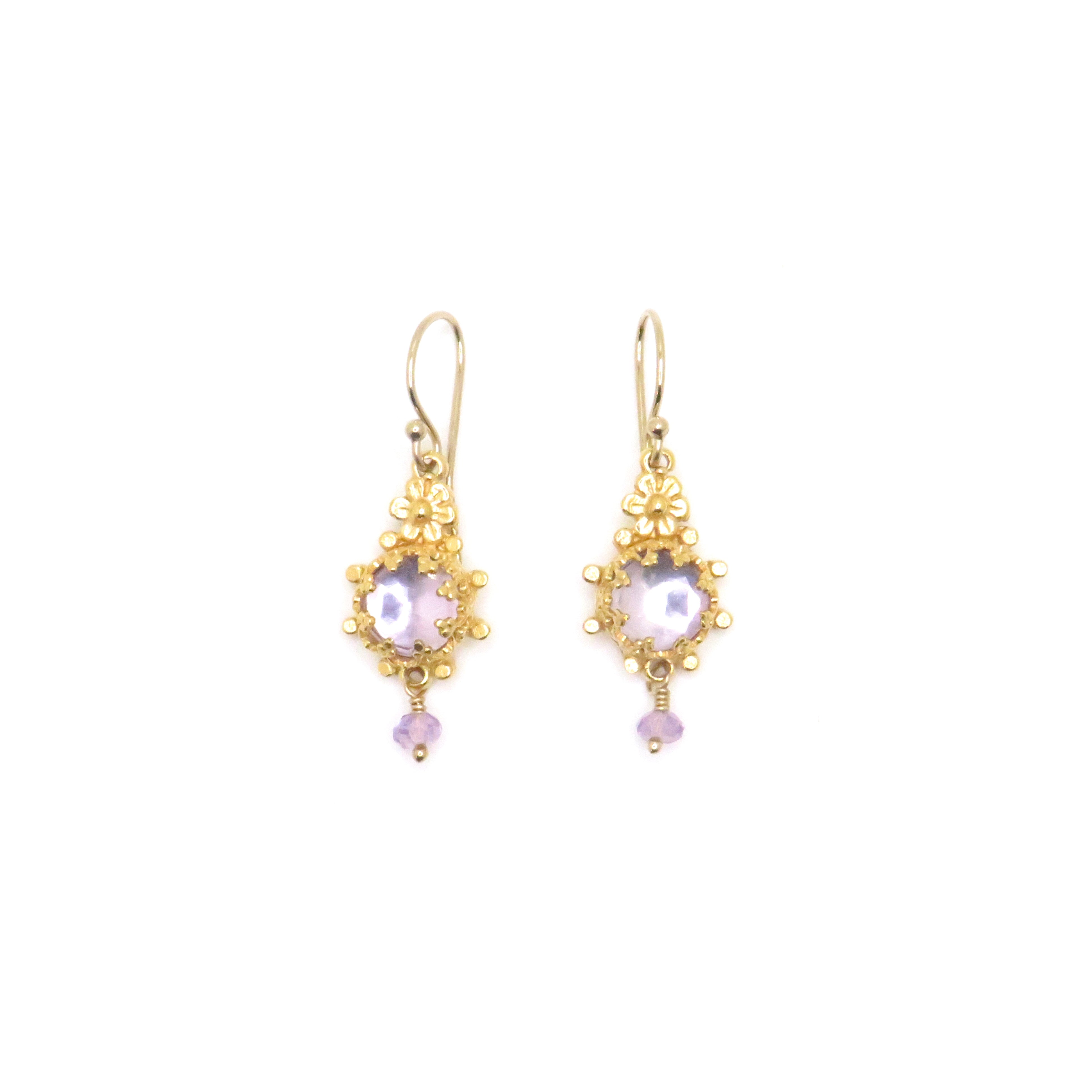 gold earring with purple gemstones