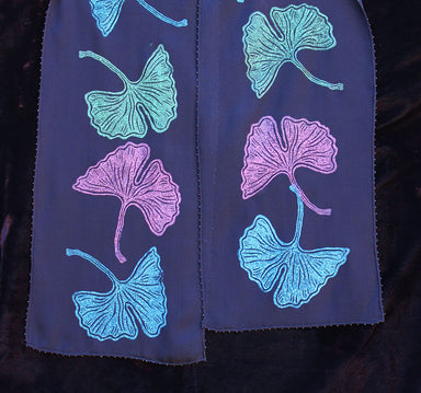 Ginko Fall Scarf by Jody Bare, a luxurious 100% silk accessory adorned with vibrant sapphire and gold prints on a white beaded chiffon, perfect for transforming any dull outfit into a chic statement that says 'Yes, I do brunch in style.'