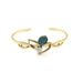 Gold bracelet with green gemstone