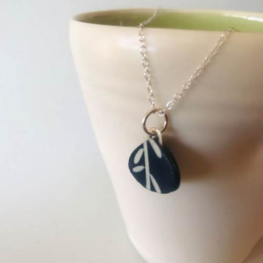 Raindrop Botanical Cyanotype Necklace by Joanna Lynn Taylor, featuring a one-of-a-kind blue-and-white Southwestern botanical pendant on a hammered silver chain—nature’s tiny art show, no RSVP required.