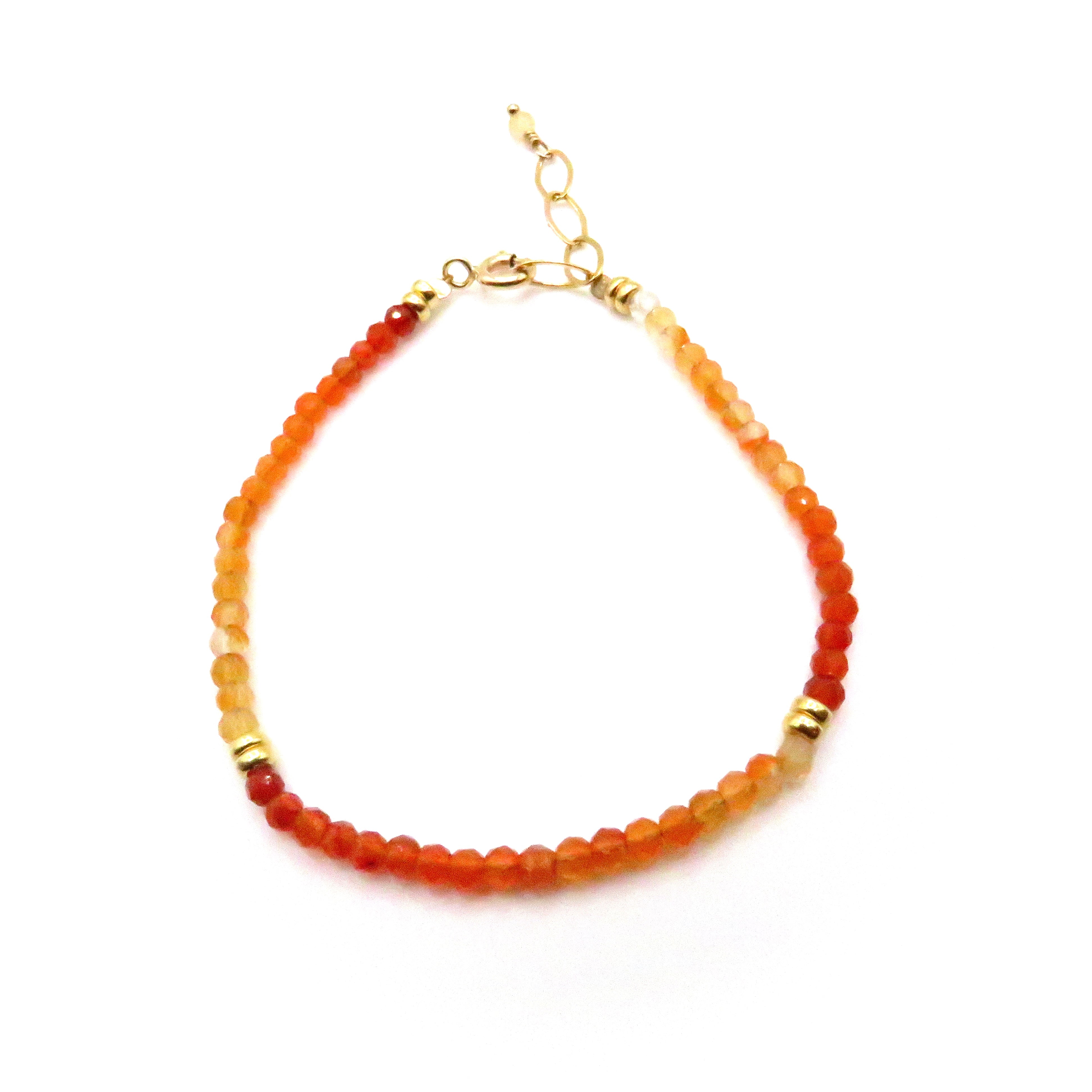 orange gemstone and gold bracelet