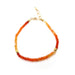 orange gemstone and gold bracelet