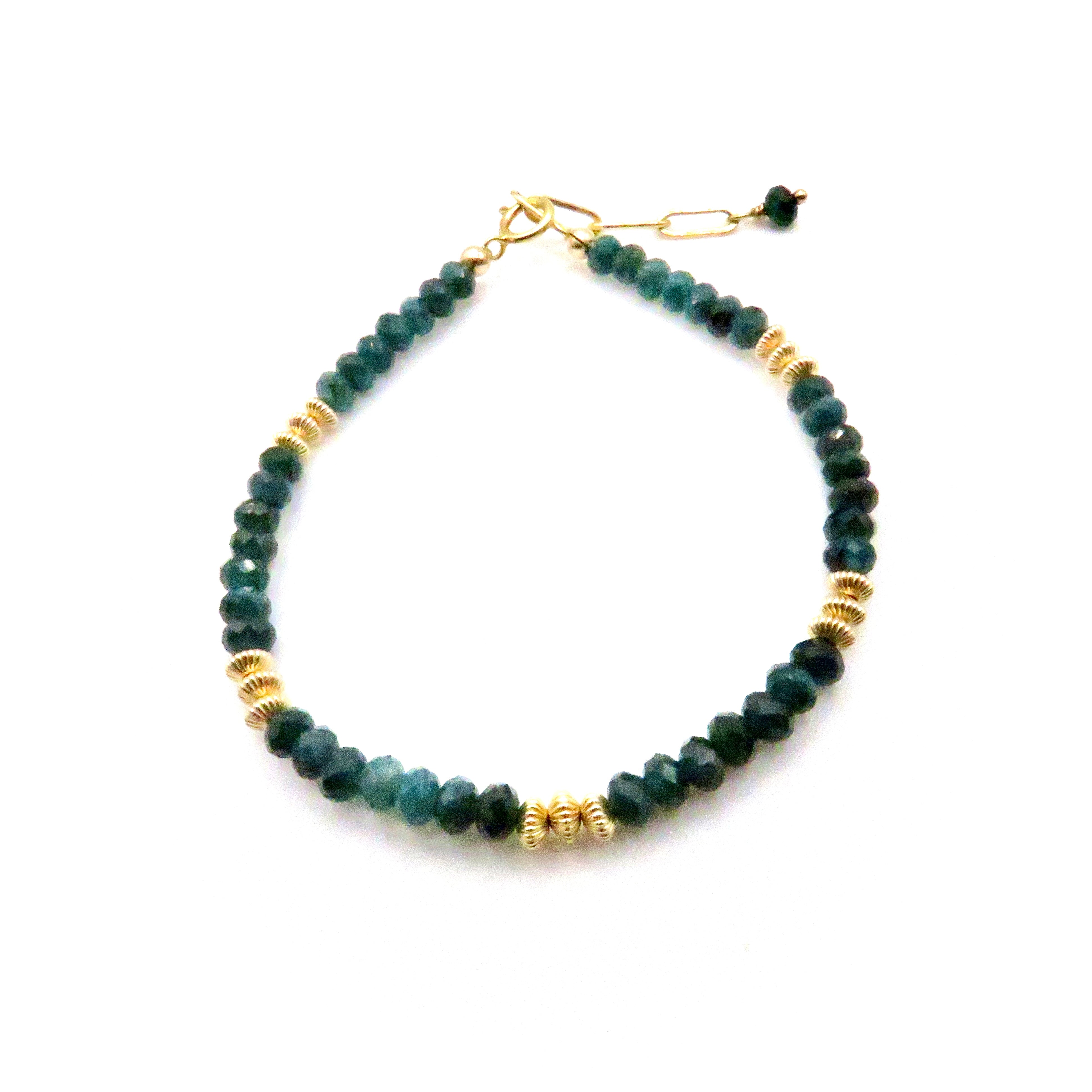 green gemstone and gold bracelet