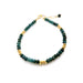 green gemstone and gold bracelet