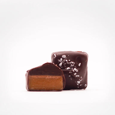 Tempting Sea Salt Dark Chocolate Caramels from Marini’s Handmade Chocolates & Candies, featuring a creamy caramel core enveloped in luxurious dark chocolate and finished with sea salt, offering a delightful treat.