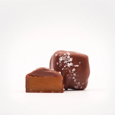 Delicious Sea Salt Chocolate Caramels from Marini’s Handmade Chocolates & Candies, showcasing a smooth caramel center coated in rich milk chocolate and topped with sea salt, perfect for sweet indulgence.