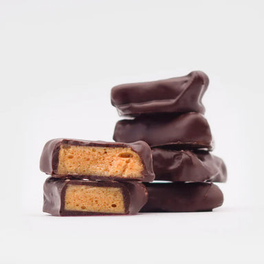 Marini's Handmade Chocolates & Candies displaying rich honeycomb treats dipped in dark chocolate, offering a crispy, sweet delight.