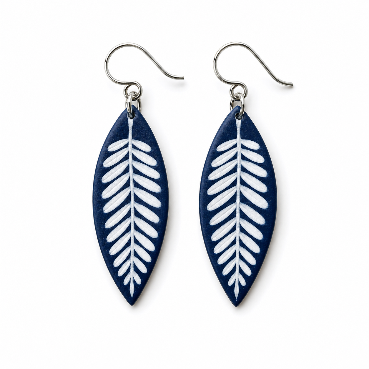 A pair of navy blue and white leaf-shaped dangle earrings with silver fishhook wires, shown on a plain white background.