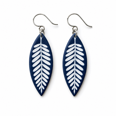 A pair of navy blue and white leaf-shaped dangle earrings with silver fishhook wires, shown on a plain white background.