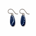 A pair of handmade dangle earrings featuring dark blue teardrop-shaped glass pendants with white speckled patterns, suspended from silver-tone fishhook wires, shown on a plain white background.