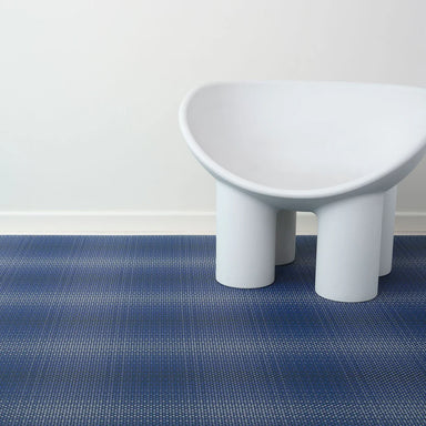 chilewich Parade Floor Mat - Ocean with a large chair