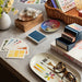 watercolor swatch playing cards with oval trays and books