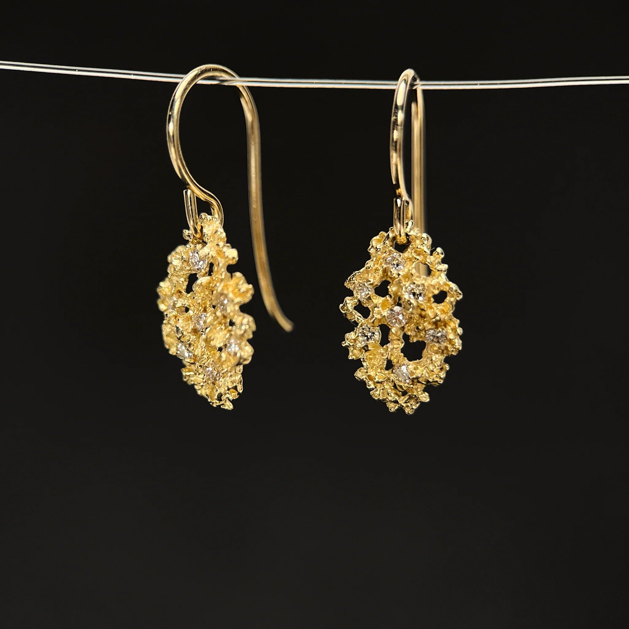 Gold clustered drop earrings with intricate design and gemstones