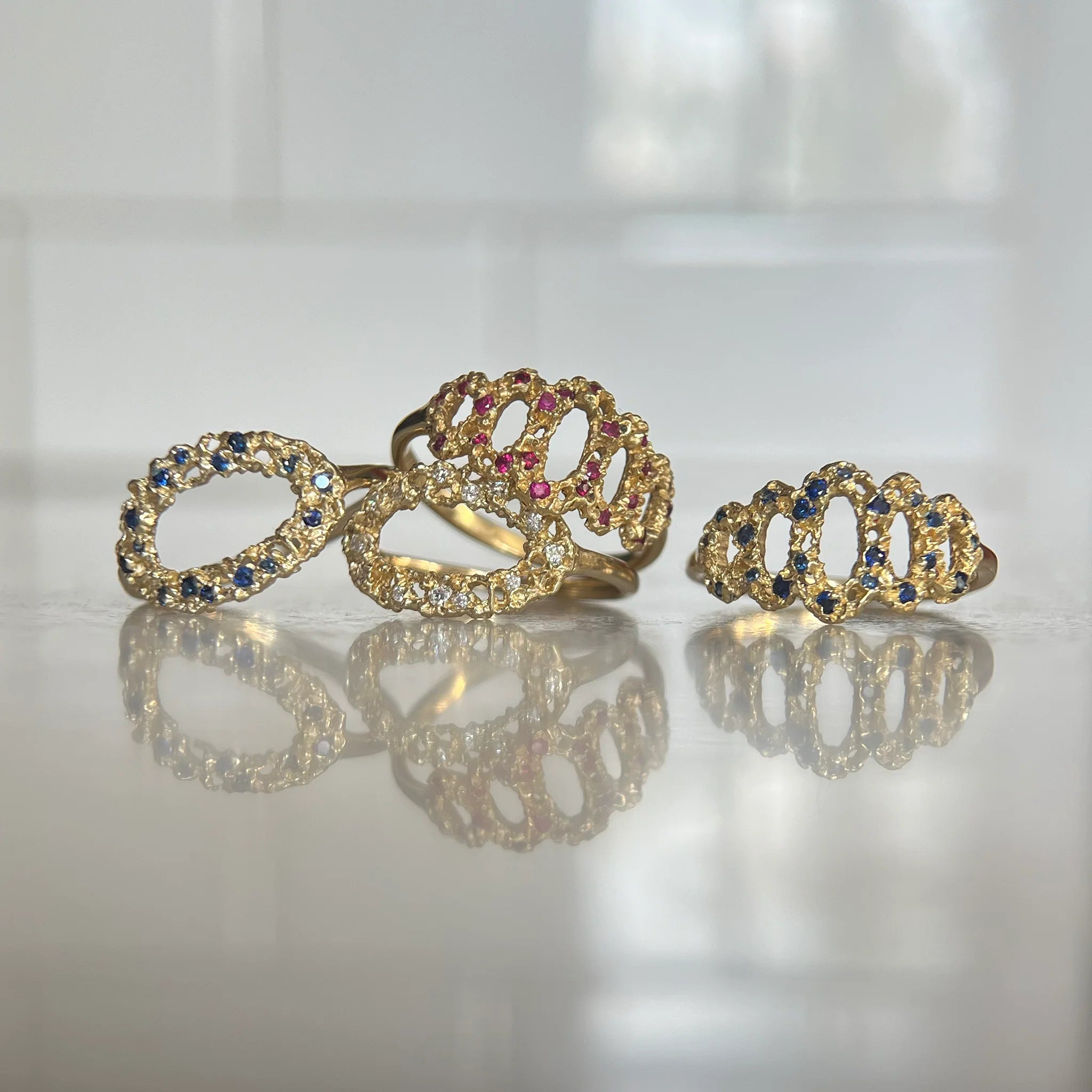 Four gold rings with gemstones 