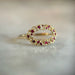 Gold clustered ring with red gemstones 