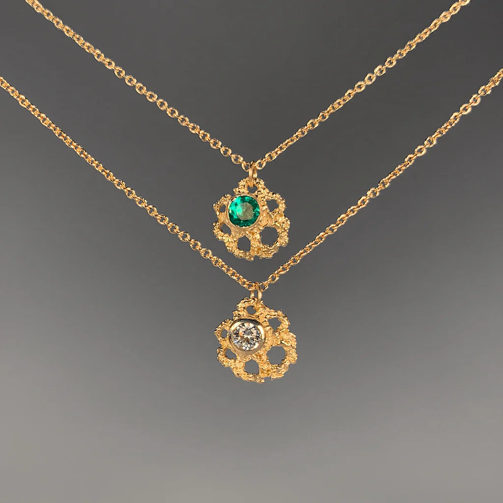 Two gold necklaces with floral pendants and gemstones