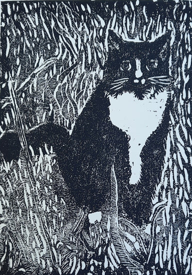 Woodcut print depicting a black and white cat surrounded by tall grass, titled 'Hearts for the Arts | Tuxedo', created by Hearts for the Arts. This artwork, framed at 12x9 inches, is valued at $200 and available for bidding to support art education.